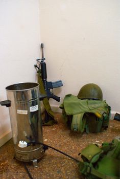 Soldiers room rifle and  boots