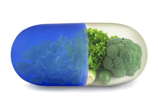 Close up of a vitamin pill filled with green vegetables 