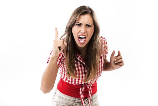 Beautiful young angry woman looking and pointing upset at camera.