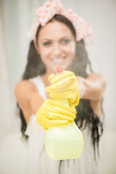 Young beautiful woman cleaning window. Selective focus.