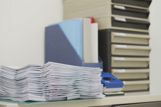 Copy of document, file work and document drawer placed on desk                             