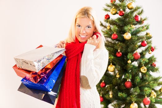 Beautiful happy christmas girl with shoping bags.