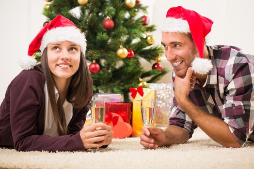 Young beautiful couple Celebrating Christmas or New Year with glass of champagne.