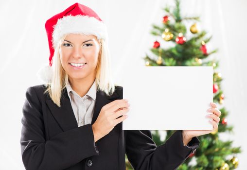 Happy Christmas businesswoman with Santa holding blank paper.