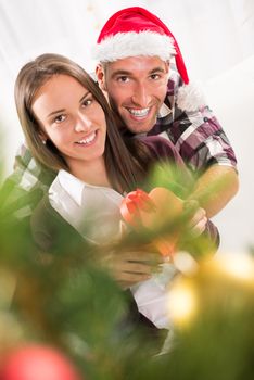 Young man gives his girlfriend a Christmas gift. 