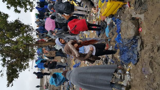 SERBIA, Sid: Refugees gather at a camp in Sid, Serbia on October 19, 2015, where they have been stranded in the cold for nearly two days before the opening of the border with Croatia that day. The area has become increasingly congested with refugees since the weekend, when Hungary closed its borders with Croatia.