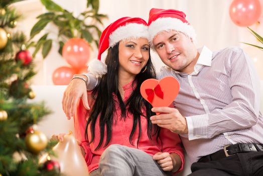 Young beautiful couple with a Christmas gifts.
