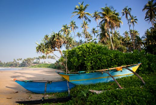 Untouched tropical beach with fishing boat in Sri Lanka