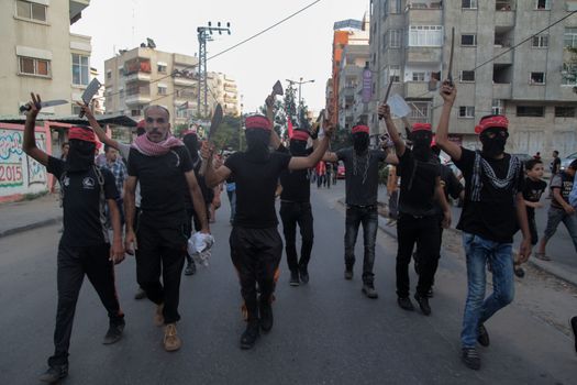 GAZA, Gaza City: Masked members of the Popular Front for the Liberation of Palestine hold weapons while participating in a protest in Gaza on October 20, 2015. The group is rallying against what it perceives to be Israeli aggression in Jerusalem, the occupied West Bank and Gaza region over the past month, during which an upsurge of violence, including stabbing and gun attacks, has led to the deaths of at least 37 Palestinians and seven Israelis. 