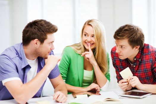 education concept - group of students gossiping at school