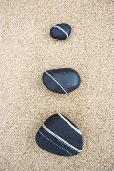Top view of sea stones over the sand 
