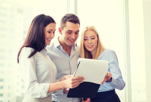 business and office concept - business team looking at clipboard