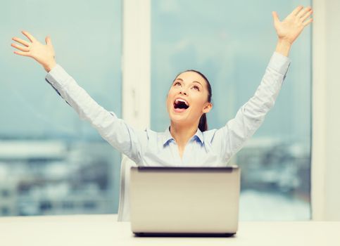 business, technology and office concept - screaming businesswoman with laptop in office