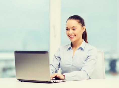 business and technology concept - businesswoman with laptop in office