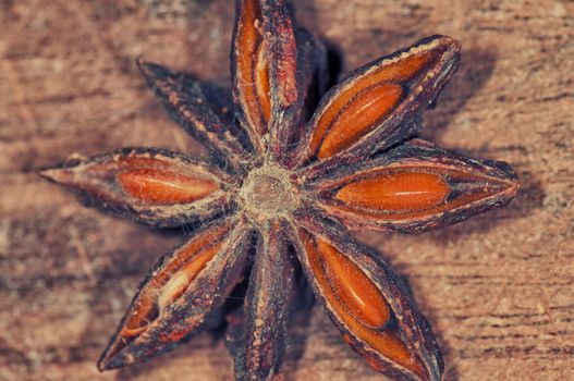 Close up of star of anise spice lying on wooden table, seasoning for cooking and baking