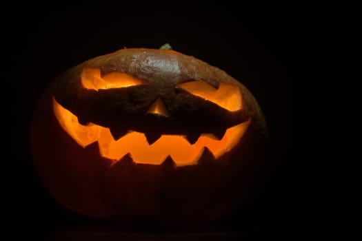 Halloween pumpkin with scary face on black backgound