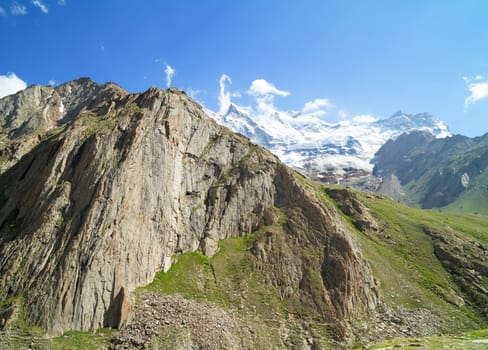 View of the steep cliffs and the glacier among snowy Himalayan peaks in Zanskar Valley in northern India