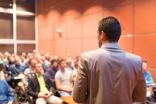 Speaker at Business Conference with Public Presentations. Audience at the conference hall. Business and Entrepreneurship concept. Background blur. Shallow depth of field.