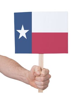 Hand holding small card, isolated on white - Flag of Texas