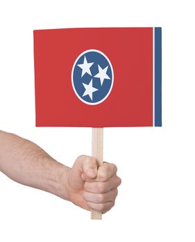 Hand holding small card, isolated on white - Flag of Tennessee