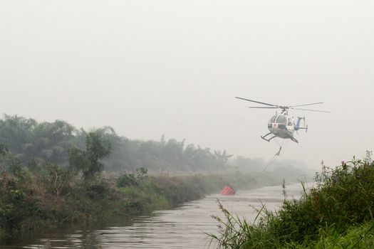  INDONESIA, Kubu Raya: Thick smoke rises up from the fire spot at Kubu Raya district, in West Kalimantan province, on October 21, 2015. Indonesia launched its biggest operation ever to combat fires blanketing Southeast Asia in haze, an official said, with dozens of planes and thousands of troops battling the widespread blazes. 	