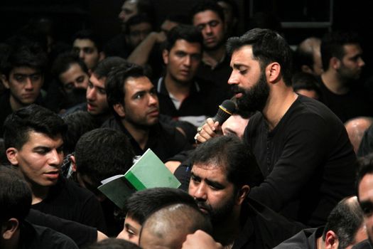 IRAN, Tehran : Hundreds of Shia Muslims gather in Reyhane-Al-Hossein complex building for mourning session in tribute to imam Husayn ibn Ali on October 21, 2015, the 8th night of Muharram. one of the holy months in the Islamic calendar in Tehran, Iran. 
