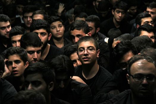 IRAN, Tehran : Hundreds of Shia Muslims gather in Reyhane-Al-Hossein complex building for mourning session in tribute to imam Husayn ibn Ali on October 21, 2015, the 8th night of Muharram. one of the holy months in the Islamic calendar in Tehran, Iran. 