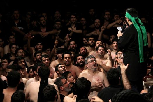 IRAN, Tehran : Hundreds of shirtless Shia Muslims gather in Reyhane-Al-Hossein complex building for mourning session in tribute to imam Husayn ibn Ali on October 21, 2015, the 8th night of Muharram. one of the holy months in the Islamic calendar in Tehran, Iran. 