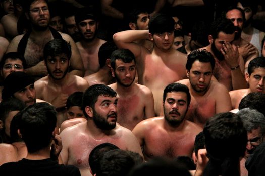 IRAN, Tehran : Hundreds of shirtless Shia Muslims in Reyhane-Al-Hossein complex building attend mourning session in tribute to imam Husayn ibn Ali on October 21, 2015, the 8th night of Muharram. one of the holy months in the Islamic calendar in Tehran, Iran. 
