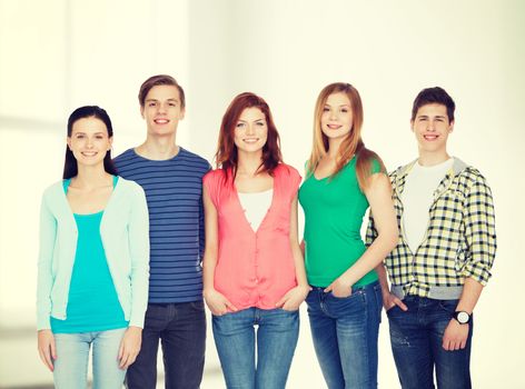 education and people concept - group of smiling students standing