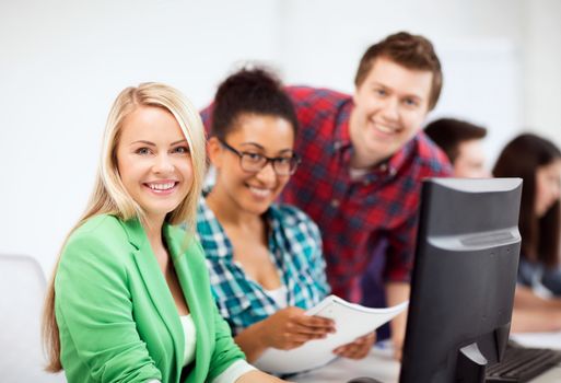 education, technology and internet - students with computer studying at school