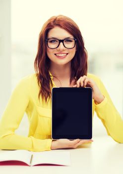 education, technology and internet concept - smiling student girl in eyeglasses with tablet pc at school