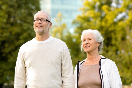 family, age, tourism, travel and people concept - senior couple in city park