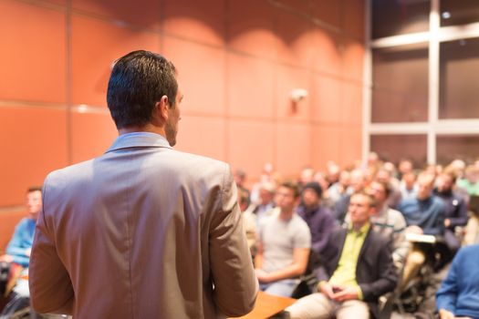 Speaker at Business Conference with Public Presentations. Audience at the conference hall. Business and Entrepreneurship concept. Background blur. Shallow depth of field.