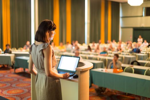 Female speaker at Business Conference and Presentation. Audience at the conference hall. Business and Entrepreneurship. Business woman. Horizontal composition.