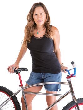 Isolated Hispanic female standing behind her mountain bike