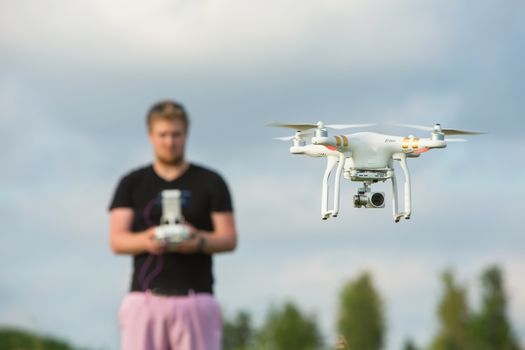 Single adult using remote control for a camera drone