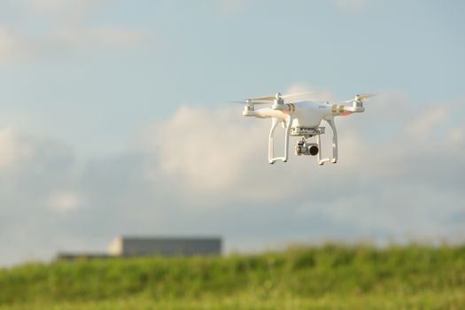 Camera drone quadrocoptor in mid air near building