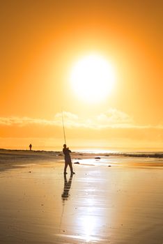 lone fisherman fishing on the beach in Ballybunion county Kerry Ireland