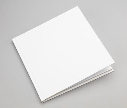 Blank book with ajar white cover 8,5 x 8,5 in