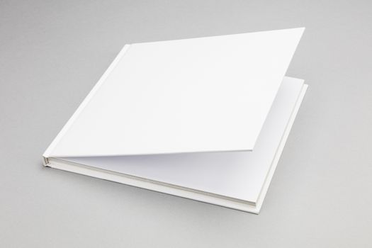 Blank book with ajar white cover 8,5 x 8,5 in