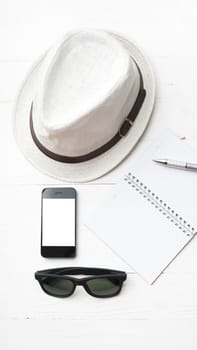 hat with summer tools over white table