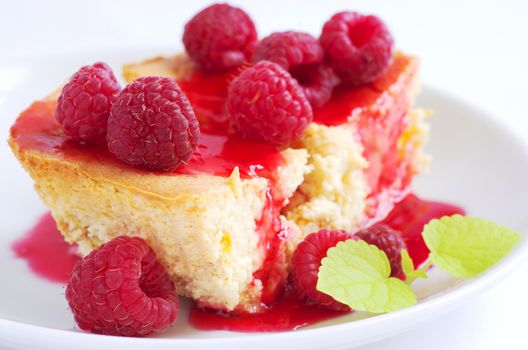 cake with raspberries and cream cheese decorated with fresh raspberries and mint. the toning. selective focus