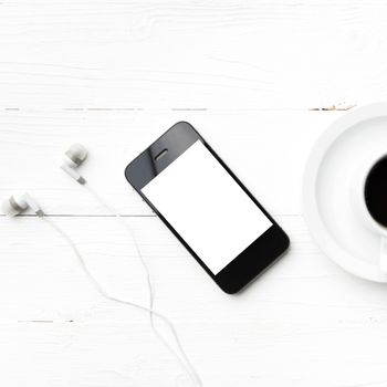 cellphone and coffee cup over white table