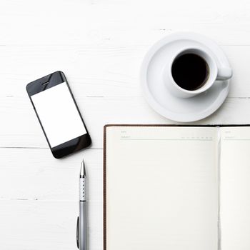 cellphone with notebook and coffee cup over white table