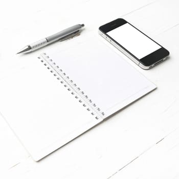 cellphone with notepad and pen over white table