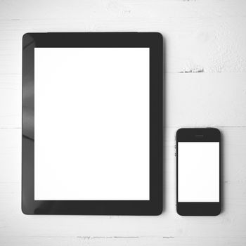 tablet and cellphone over white table black and white color style