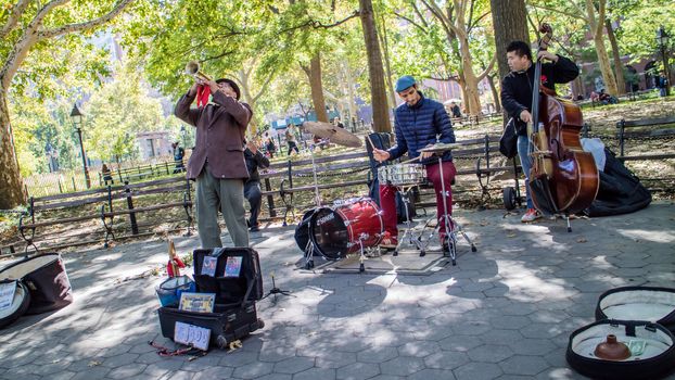NEW YORK, USA, October 10, 2015: An unidentified group of musicians perform their songs in Washington Square Garden in Manhattan, New York.