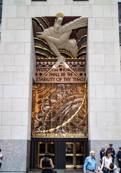 NEW YORK, USA, October 10, 2015: Unidentified people walking in front of Rockfeller Center building in Manhattan, New York.