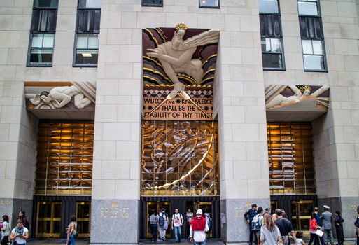 NEW YORK, USA, October 10, 2015: Unidentified people walking in front of Rockfeller Center building in Manhattan, New York.